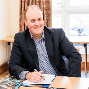 Peter Williams at a desk